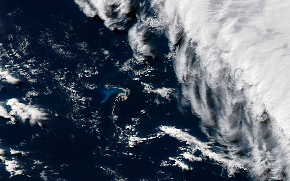 The Havre Seamount volcano erupted a tightly-packed raft of floating pumice (center) on July 19 and 20, 2012. Over several weeks, wind and waves dispersed the pumice among the remote Kermadec Islands, northeast of New Zealand. This satellite image shows the start of the spread of the pumice. (NASA/Jeff Schmaltz LANCE/EOSDIS MODIS Rapid Response Team, GSFC) 