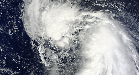 Satellite sees two vortices circling a newborn Tropical Storm Man-yi's center
