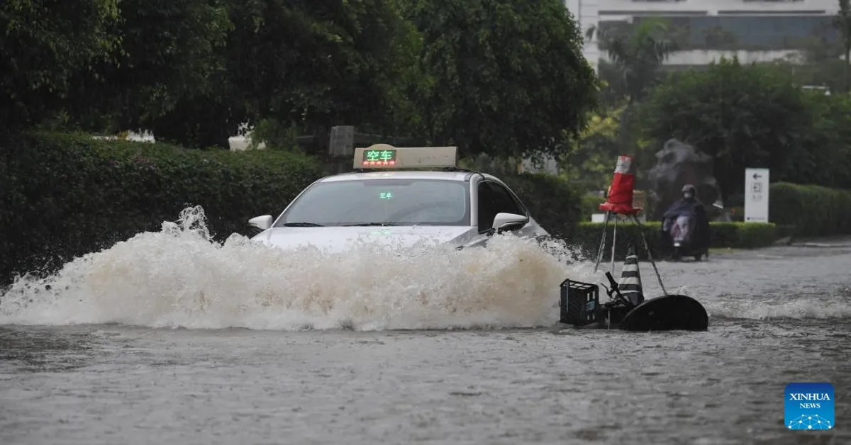 A taxi moves through a waterlogged road in Sanya, south China's Hainan Province, October 28, 2024