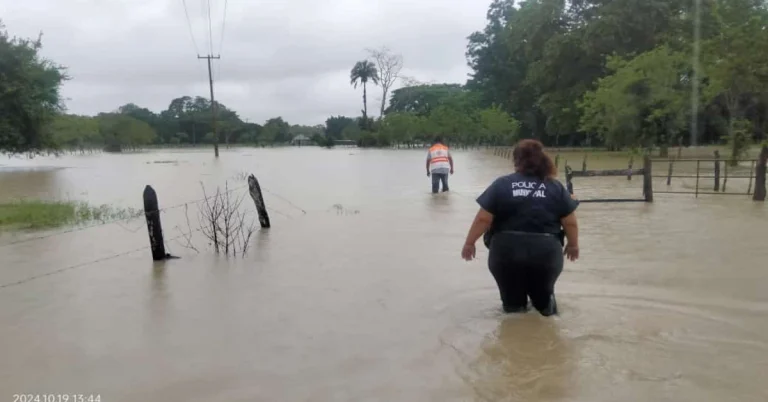 Officials wading through flooded streets to asses damages in the Nuevo San Carlos ejido.