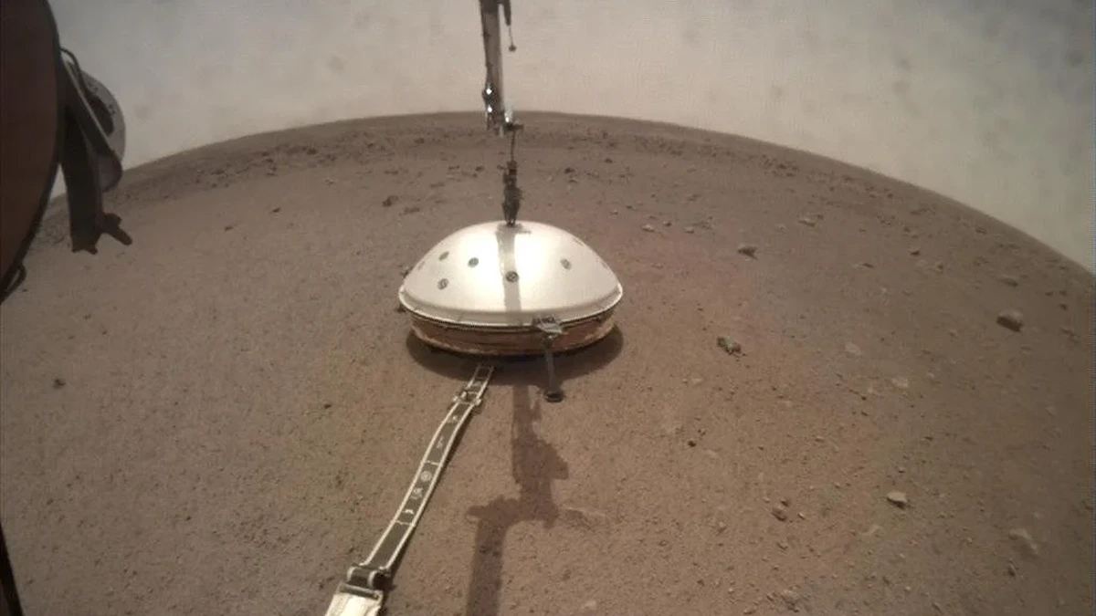 A camera on the robotic arm of NASA’s InSight captured the lander