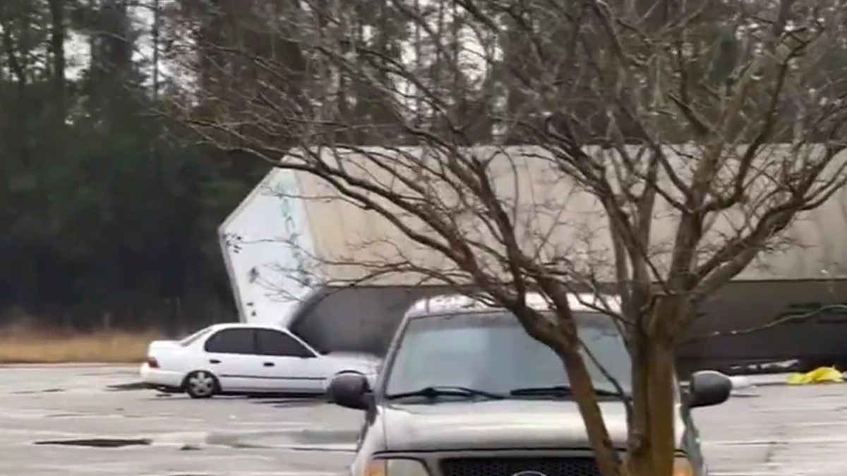Container flipped over a car in Pensacola, Florida, due to a possible tornado on Tuesday, February 11, 2025.