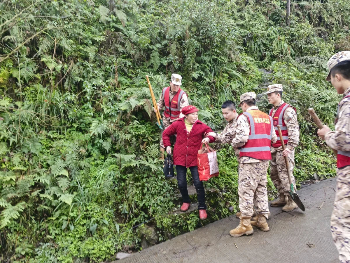 Rescuers help a senior villager evacuate in Jinping Village on February 8, 2025
