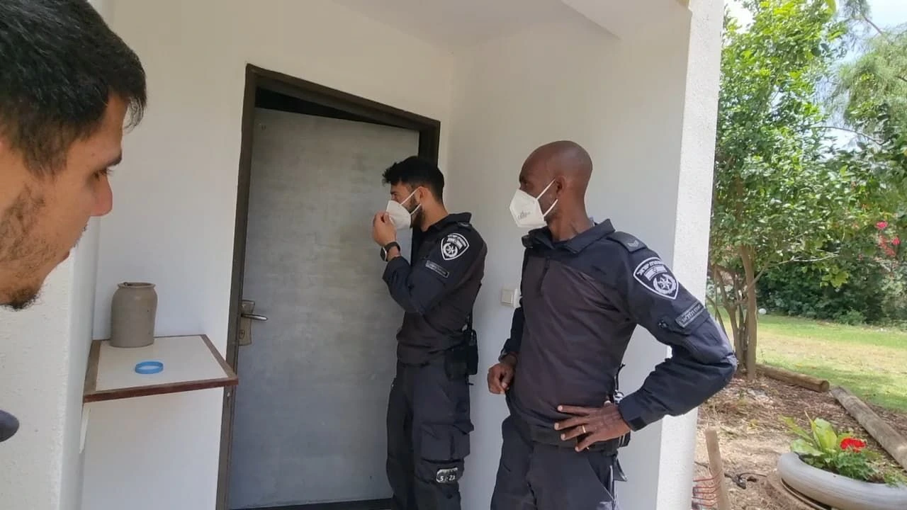 Israeli police officers going to door to door to evacuate people in high risk area