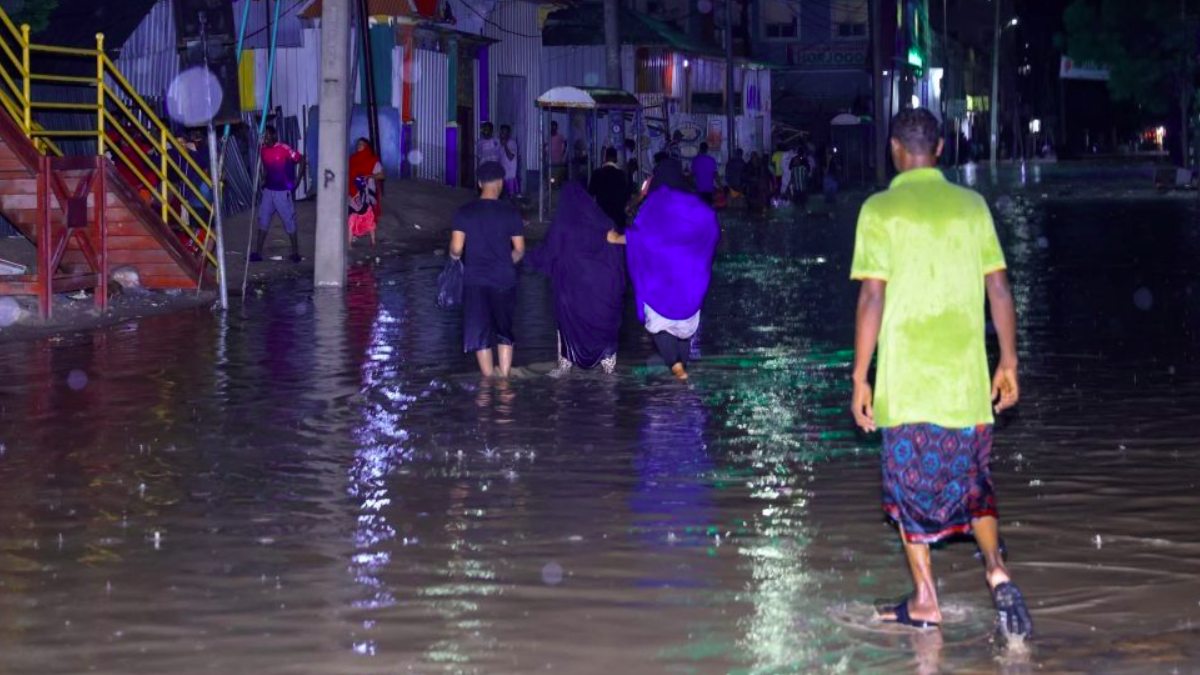 Residents traversing through floodwaters in Mogadishu following heavy rains on Friday, May 9, 2025