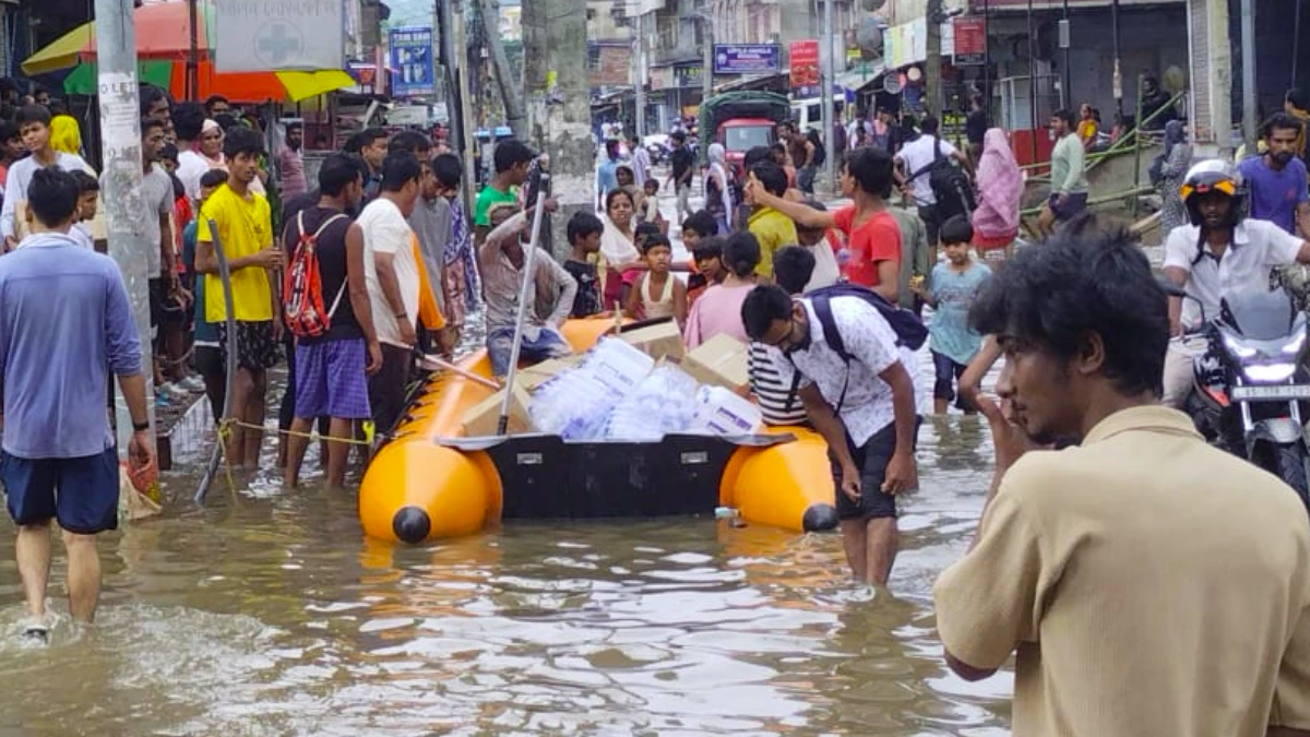 Water and supplies being delivered to flood hit area in Assam via boats. Credit: Assam Police