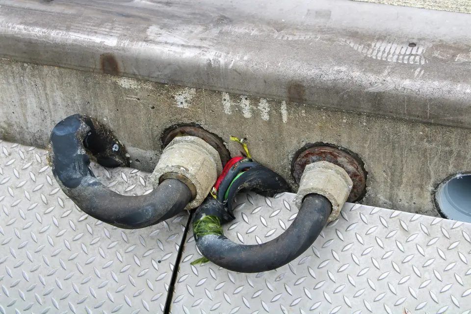 The aftermath of the tsunami at Crescent City's harbor reveals compromised electrical conduits,