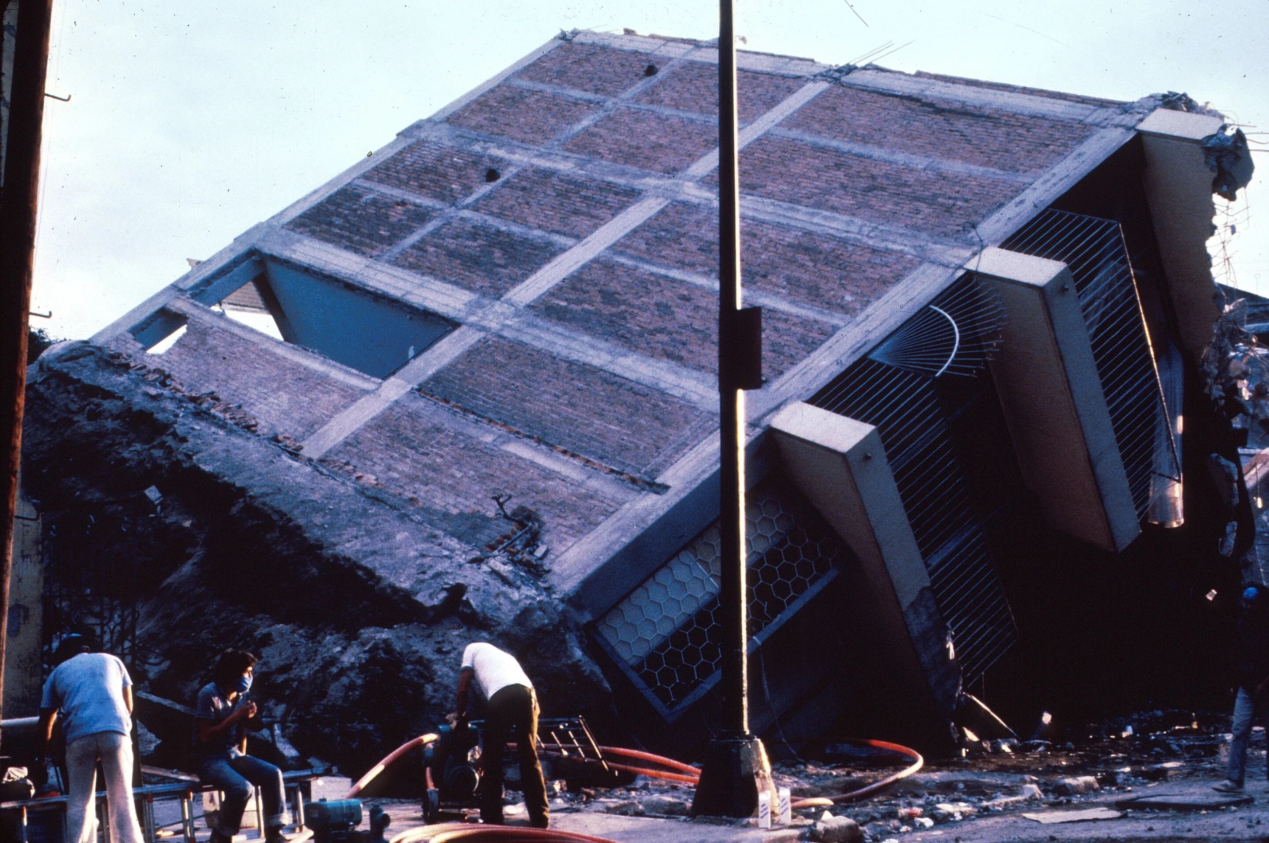 Eight-story frame structure with brick infill walls broken in two. The foundation also came off.