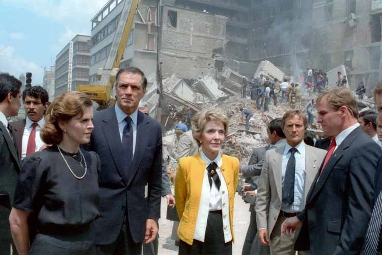 First ladies Paloma Cordero of Mexico (left) and Nancy Reagan of the United States (right) with U.S. Ambassador to Mexico, John Gavin observing the damage done by the earthquake.