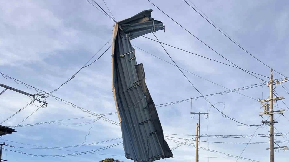 Part of a roof hanging from and elctrical wire in Shizuoka Prefecture after getting blown off due to strong winds from Tropical Storm Peripah. Credit: Chubu Power Grid