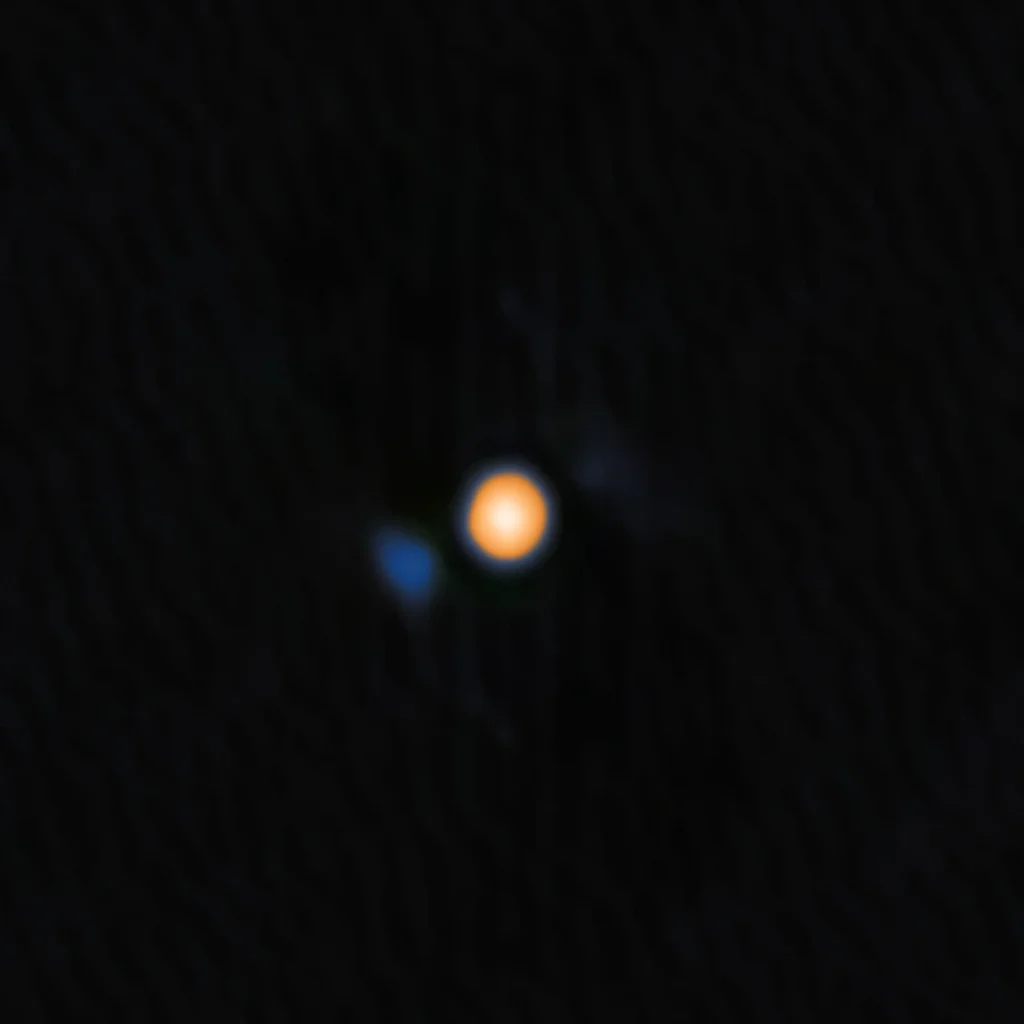 An image of Betelgeuse, the yellow-red star, and the signature of its close companion, the faint blue object