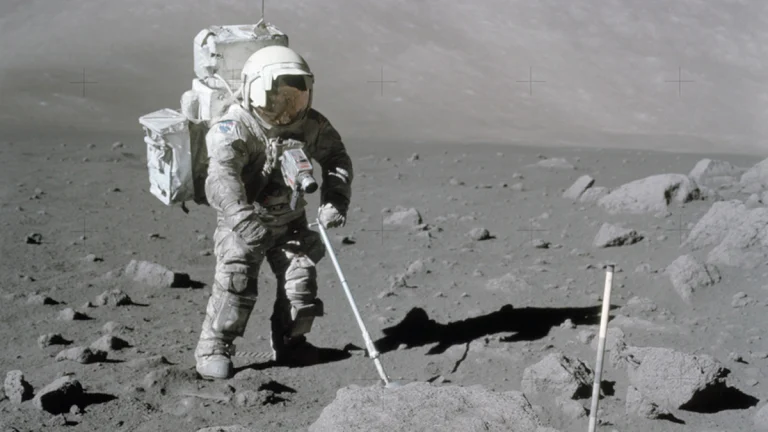 Apollo 17 astronaut Harrison Schmitt collects lunar samples with an adjustable sampling scoop during the 1972 moon mission
