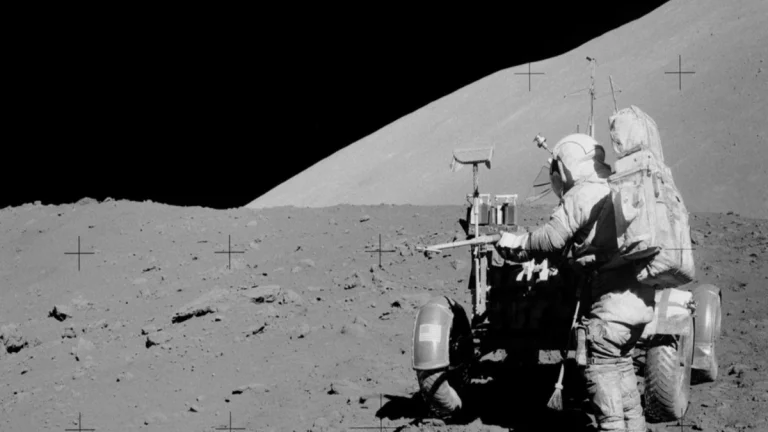 Commander Eugene Cernan retrieves a drive tube from the Lunar Roving Vehicle during an Apollo 17 EVA