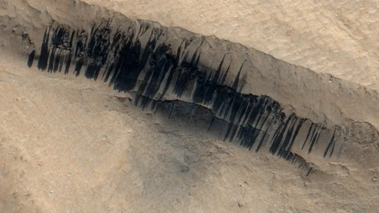 CaSSIS imagery reveals faint impact craters and dust-streak formations on Mars, created by a meteoroid strike between 2013 and 2017.