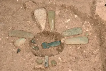 The team excavated jade axes and ornaments that were likely left later, in return trips to the site, after builders made offerings to the cruciform cache and filled it in-1