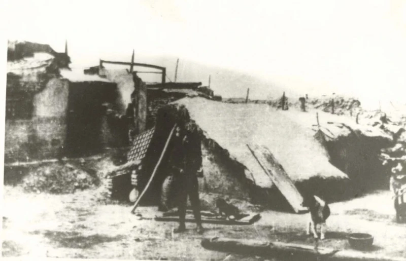 A man stands in front of his temporary shelter in the town of Jingning, Gansu, in early 1921