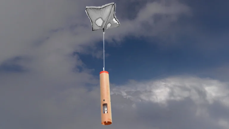 An NRD41 dropsonde, like the ones dropped into Hurricane Melissa, with Hurricane Irma in the background. Dropsonde technology is developed by NSF NCAR and manufactured by Vaisala