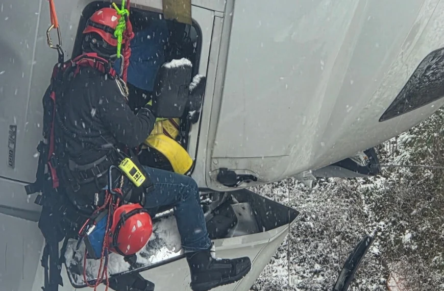 Firefighter rescuing a driver after a truck slide of on US 35 in Mason County, West Virginia on December 2, 2025