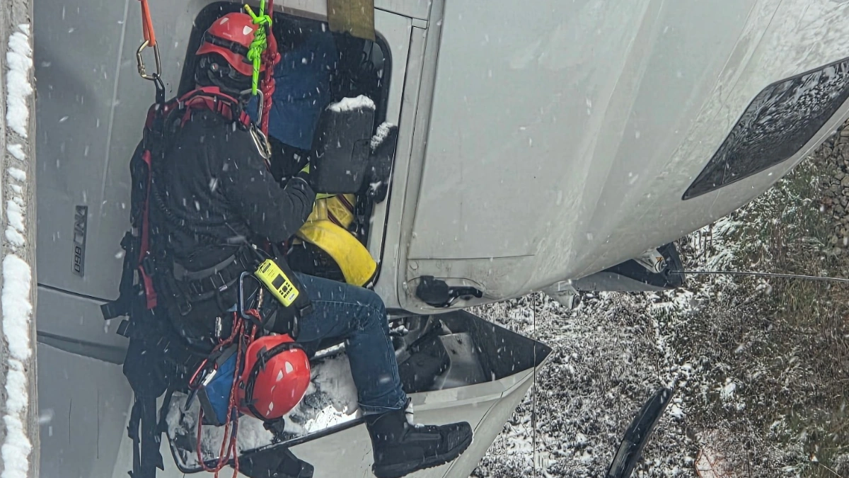 Firefighter rescuing a driver after a truck slide of on US 35 in Mason County, West Virginia on December 2, 2025