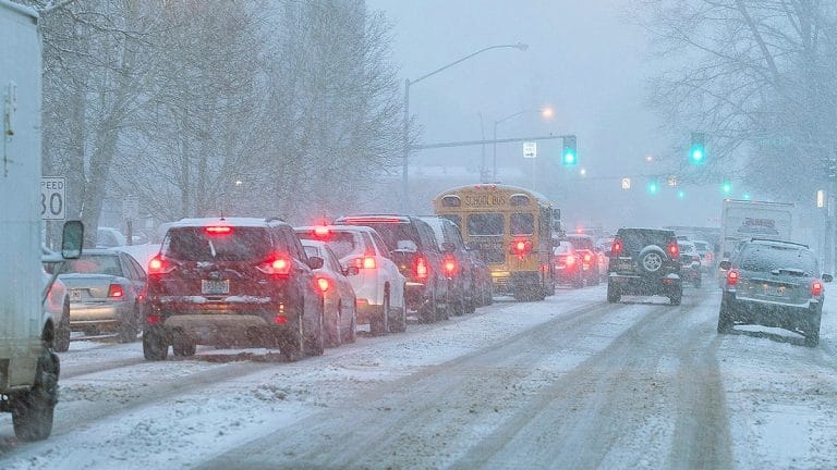 strings of stoplights driving under snow stock