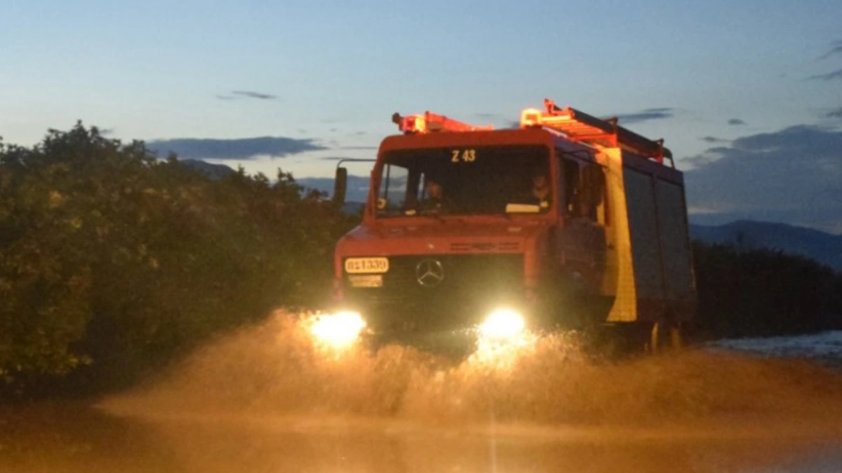 A firetruck driving through floodwaters in Attica, Greece, on January 21, 2026. Credit: Hellenic Fire Corps