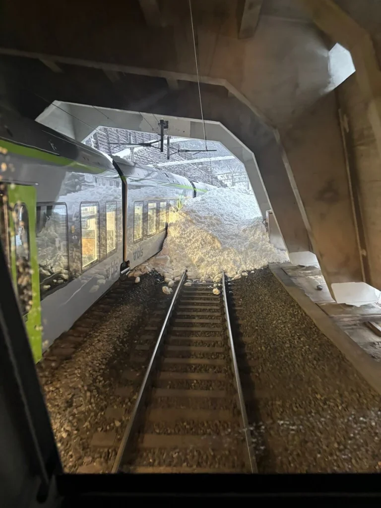 Snow accumulation on the side of the derailed train on February 16, 2026