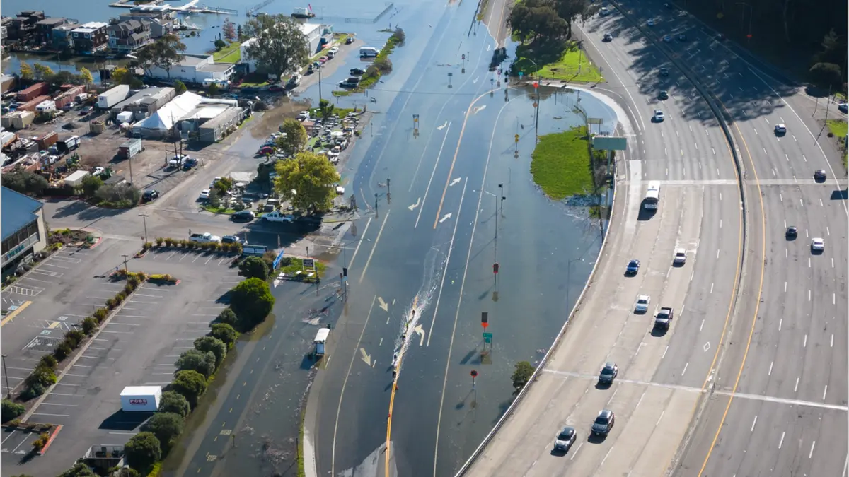 An unusually high tide, called a King Tide, floods a highway on-ramp in Northern California in January 2023. Sea level rise and El Niños can exacerbate this type of flooding