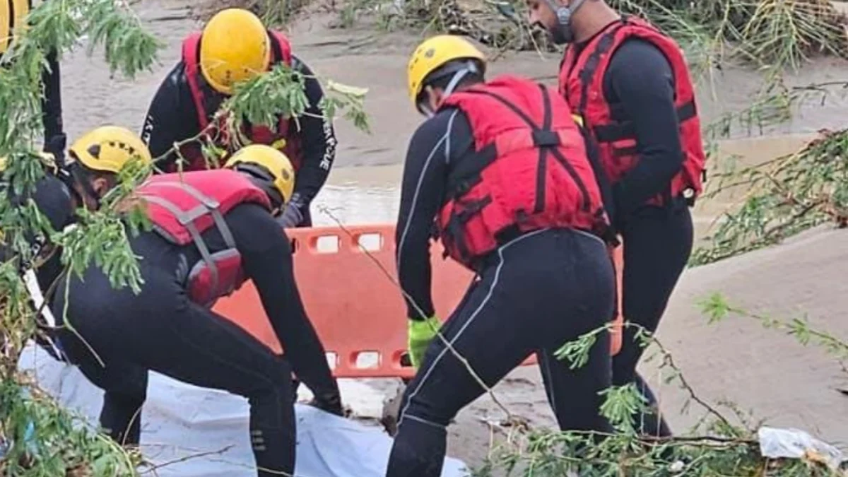 Rescue operative recovering the body of flood victim in Barka, Oman on march 22, 2026