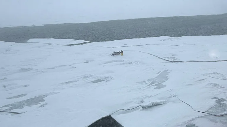 Snow mobile stuck in ice on Lake Michigan on March 16, 2026, amid historic blizzard. Credit: USCG Great Lakes