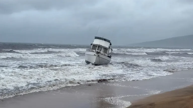 a boat is grounded on a beach off Kihei, Hawaii, during heavy rain on Friday, March 13, 2026