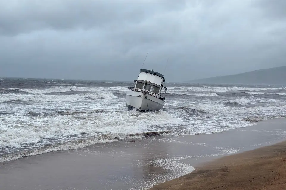 a boat is grounded on a beach off Kihei, Hawaii, during heavy rain on Friday, March 13, 2026