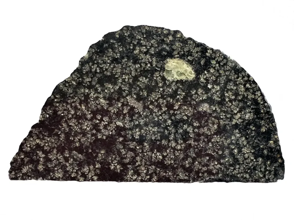 A slice of NWA 12774.The green circle is an olivine crystal, a magnesium-rich mineral