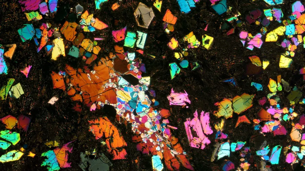 A thin slice of the NWA 12774 meteorite. The colors arise from various minerals responding to the slice’s illumination by cross-polarized light