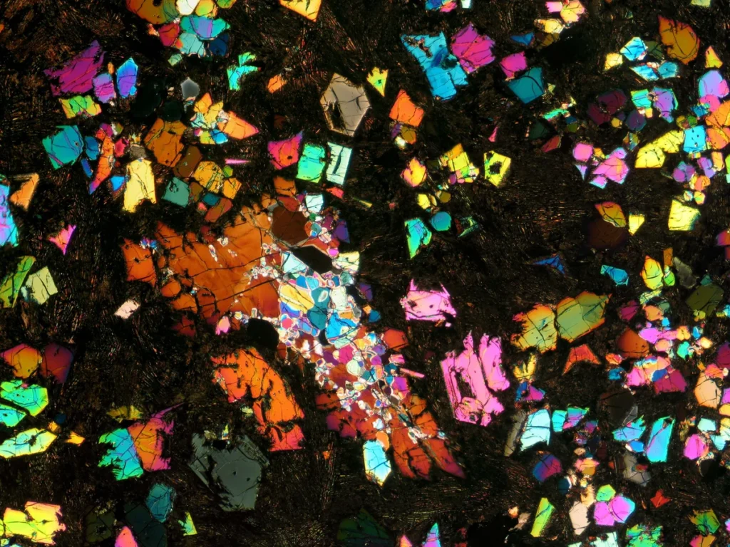 A thin slice of the NWA 12774 meteorite. The colors arise from various minerals responding to the slice’s illumination by cross-polarized light