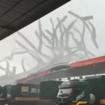 A tornado tears apart a warehouse roof in Xingning District, Nanning, Guangxi, China, on June 7, 2026