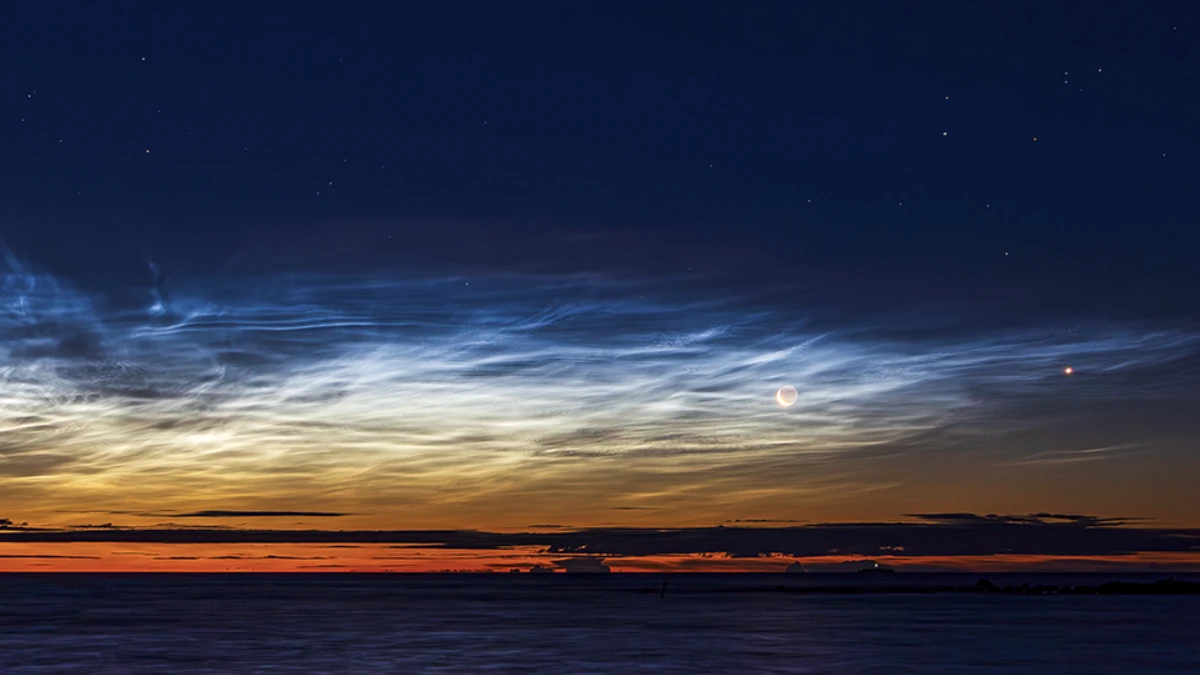 Late season noctilucent clouds and the crescent moon seen from Björköby (Korsholm municipality), Finland on August 21st 2025. Credit: Sebastian Sainio