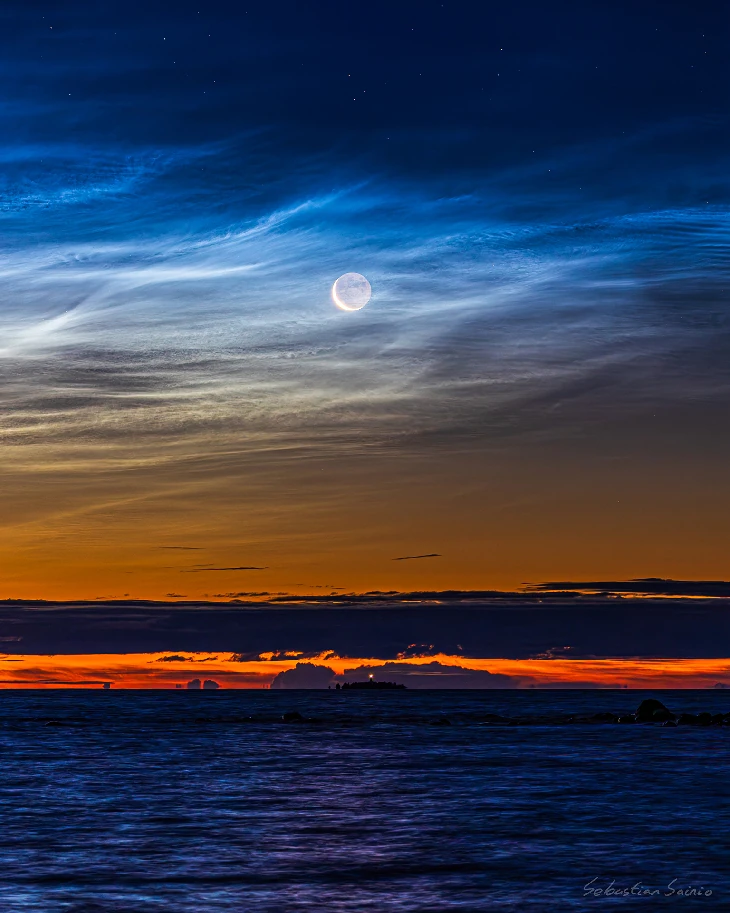 Late season noctilucent clouds and the crescent moon seen from Björköby (Korsholm municipality), Finland on August 21st 2025. Credit: Sebastian Sainio
