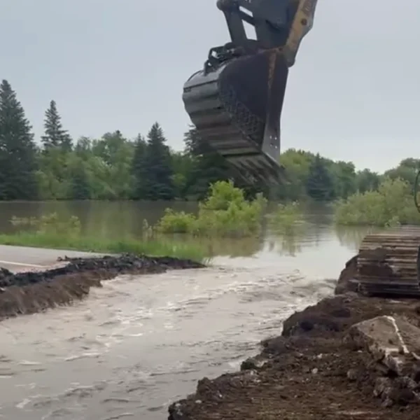 Section of Highway 10 being cut to control flooding of Swan River in Minitonas, Manitoba on June 9, 2026
