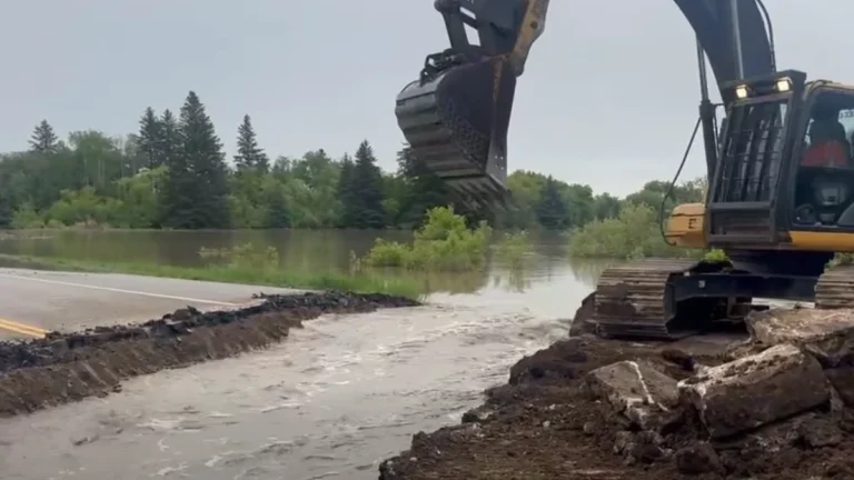 Section of Highway 10 being cut to control flooding of Swan River in Minitonas, Manitoba on June 9, 2026