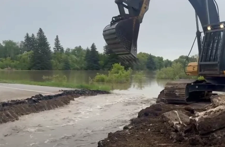 Section of Highway 10 being cut to control flooding of Swan River in Minitonas, Manitoba on June 9, 2026