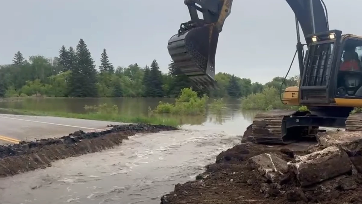 Section of Highway 10 being cut to control flooding of Swan River in Minitonas, Manitoba on June 9, 2026