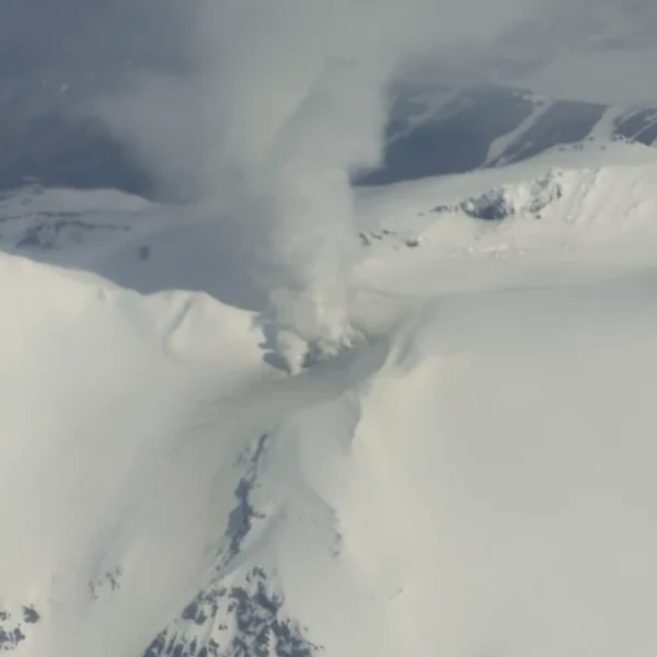 Vigorous steaming is visible from the persistently active fumarole field to the west of the summit of Mount Kupreanof in this oblique aerial photo taken on June 5, 2026. Although steaming in this location is typical, the degassing plume now contains more sulfur dioxide, indicating that magma has intruded to relatively shallow levels beneath the volcano. Credit: Carson Klemp.
