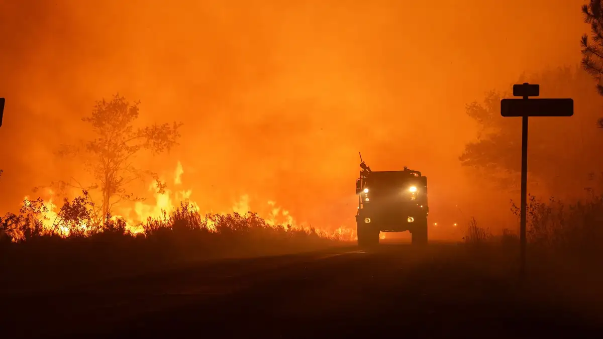 Firefighters battle a rapidly spreading wildfire near Lège-Cap-Ferret, Gironde, France, on July 24, 2026