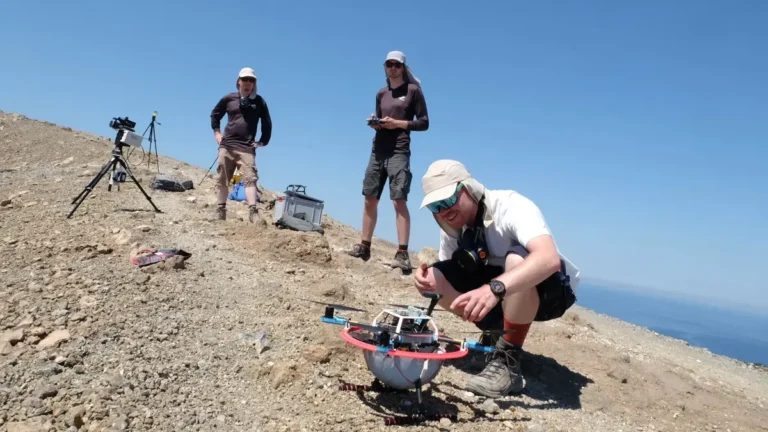 Researcher Marius Schaab (front) from TUM inspects the drone, which is set to fly over volcanic gases in a crater on Vulcano