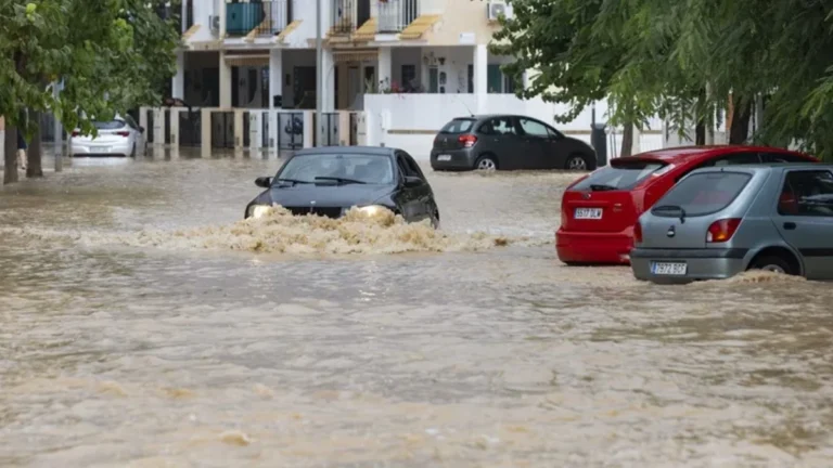 A car drives through a flooded street in Los Alcázares, Murcia, Spain. Credit: EFE/Marcial Guillén